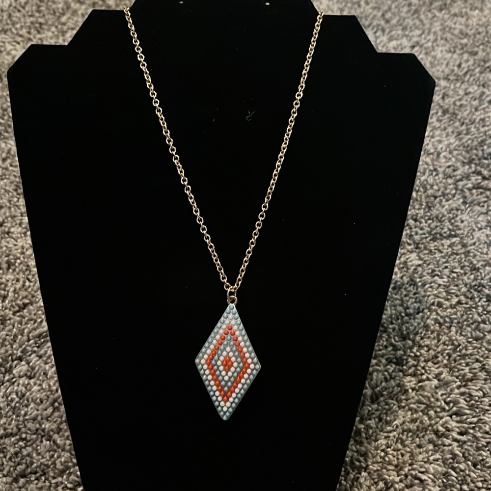 INC gold tone necklace with medallion. White, coral & pale blue beads.
